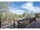 A view from the wooden deck highlighting the beautiful trees and green foliage in the backyard and beyond at 17593 E Temple Dr, Aurora, CO 80015