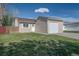 The front yard features a well-kept lawn and an attached one car garage at 17593 E Temple Dr, Aurora, CO 80015