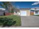 The home's front yard features a well-maintained lawn and a garage door at 17593 E Temple Dr, Aurora, CO 80015
