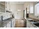 Bright kitchen featuring modern appliances, granite countertops and tile floor at 17593 E Temple Dr, Aurora, CO 80015