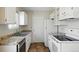 Clean kitchen with granite countertops, appliances, and tile flooring at 17593 E Temple Dr, Aurora, CO 80015