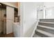 Laundry area with washer, dryer, water heater, and stairs leading to the home's main floor at 17593 E Temple Dr, Aurora, CO 80015