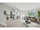 Cozy living room with neutral tones, a large window, and an open floor plan at 17593 E Temple Dr, Aurora, CO 80015