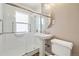 Clean bathroom with a glass-enclosed shower, pedestal sink and white tile at 5142 S Pennsylvania St, Littleton, CO 80121