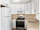 Modern kitchen featuring stainless steel appliances and bright white cabinets at 5142 S Pennsylvania St, Littleton, CO 80121