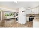 Modern kitchen open to the living room featuring stainless steel appliances and white cabinets at 5142 S Pennsylvania St, Littleton, CO 80121