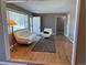 Bright living room with hardwood floors, neutral paint and plentiful natural light from large window at 5142 S Pennsylvania St, Littleton, CO 80121