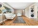 Bright living room featuring hardwood floors, modern white furniture, and natural light at 5142 S Pennsylvania St, Littleton, CO 80121