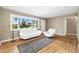 Bright living room featuring hardwood floors, modern white furniture, and natural light at 5142 S Pennsylvania St, Littleton, CO 80121