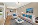 Bright living room features neutral tones, wood floors, and ample natural light at 5142 S Pennsylvania St, Littleton, CO 80121