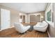 Bright living room featuring hardwood floors, modern white furniture, and natural light at 5142 S Pennsylvania St, Littleton, CO 80121