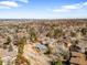 Wide aerial view of houses nestled amongst mature trees in a neighborhood at 14475 Foothill Rd, Golden, CO 80401