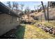 Backyard features a terraced landscape with rock accents, fencing, and a grassy area at 14475 Foothill Rd, Golden, CO 80401