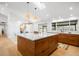 Bright modern kitchen with a large island with a marble countertop and light wood flooring at 14475 Foothill Rd, Golden, CO 80401