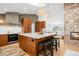 Modern kitchen featuring a center island with seating, stone fireplace and bright lighting at 14475 Foothill Rd, Golden, CO 80401