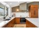 Modern kitchen featuring an island with white countertops and wood cabinets at 14475 Foothill Rd, Golden, CO 80401