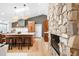 Modern kitchen featuring a large island, stone fireplace and wood cabinets with stainless steel appliances at 14475 Foothill Rd, Golden, CO 80401