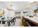 Open concept kitchen and dining area featuring an island with counter seating at 14475 Foothill Rd, Golden, CO 80401