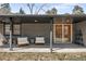 Covered porch area with contemporary outdoor seating and double door entry at 14475 Foothill Rd, Golden, CO 80401