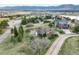 Expansive aerial view of a home with a picturesque mountain backdrop and lush green surroundings at 1285 Spinnaker Trl, Monument, CO 80132