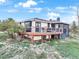 Backyard with deck perfect for outdoor dining and entertaining with lush greenery and mature trees at 1285 Spinnaker Trl, Monument, CO 80132