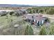 Scenic backyard view with a deck, hot tub, trampoline, and lush greenery overlooking a serene lake at 1285 Spinnaker Trl, Monument, CO 80132
