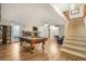 Finished basement featuring an open layout with a billiard table and staircase at 1285 Spinnaker Trl, Monument, CO 80132