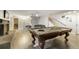 Large basement showcasing an entertainment area with a billiard table and adjacent seating at 1285 Spinnaker Trl, Monument, CO 80132