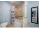 Bathroom with tiled shower and backsplash, with light blue wall at 1285 Spinnaker Trl, Monument, CO 80132