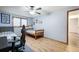 Charming bedroom with light gray walls, wood floors, ceiling fan and two twin beds at 1285 Spinnaker Trl, Monument, CO 80132
