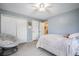 Bedroom with ceiling fan and papasan chair with closet and bathroom entrance at 1285 Spinnaker Trl, Monument, CO 80132
