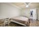 Bedroom featuring hardwood floors, neutral paint, a twin bed, and built in storage at 1285 Spinnaker Trl, Monument, CO 80132