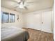 Bedroom featuring a bed, closet, and natural light from a window overlooking the greenery outside at 1285 Spinnaker Trl, Monument, CO 80132