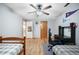 Neutral bedroom featuring ceiling fan, wood floors, and two twin beds with an adjacent desk at 1285 Spinnaker Trl, Monument, CO 80132