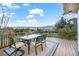 Outdoor deck features mountain and treetop views, with a dining table and chairs at 1285 Spinnaker Trl, Monument, CO 80132