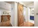 Hallway with wood floors and a barn door leading to the laundry room at 1285 Spinnaker Trl, Monument, CO 80132
