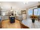 Open concept kitchen with an island, stainless appliances, mosaic backsplash, and adjacent dining area at 1285 Spinnaker Trl, Monument, CO 80132