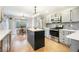 Stylish kitchen featuring gray cabinets, a center island, stainless steel appliances, and hardwood floors at 1285 Spinnaker Trl, Monument, CO 80132