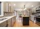 Bright kitchen features an island, stainless steel appliances, tiled backsplash, and hardwood floors at 1285 Spinnaker Trl, Monument, CO 80132