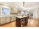 Updated kitchen boasts an island with a wine fridge, stainless steel appliances, and hardwood floors at 1285 Spinnaker Trl, Monument, CO 80132