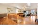 Bright open concept living room with hardwood floors, skylights, comfortable leather furniture and staircase at 1285 Spinnaker Trl, Monument, CO 80132