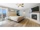 Spacious main bedroom with a fireplace, ceiling fan, and access to outdoor balcony at 1285 Spinnaker Trl, Monument, CO 80132