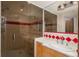 Bright bathroom with a glass-enclosed shower, white sink, and decorative tile accents at 180 N Cook St # 509, Denver, CO 80206