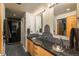 Modern bathroom featuring double sinks, granite countertops, and stylish fixtures at 180 N Cook St # 509, Denver, CO 80206
