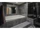 Modern bathroom featuring a soaking tub, tiled walls, glass enclosed shower, and a neutral color palette at 180 N Cook St # 509, Denver, CO 80206