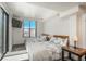 Bright bedroom with two beds, city views from the window, and a modern decor at 180 N Cook St # 509, Denver, CO 80206