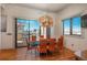 Modern dining room with designer chandelier, expansive sliding glass doors, and city view at 180 N Cook St # 509, Denver, CO 80206
