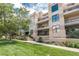 The exterior showcases a well-maintained building and beautifully landscaped grounds at 180 N Cook St # 509, Denver, CO 80206