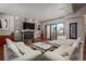 Contemporary living room with a stone fireplace, hardwood floors, and a sliding glass door to a private balcony at 180 N Cook St # 509, Denver, CO 80206