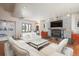 Comfortable living room featuring a stone fireplace and modern white sofas at 180 N Cook St # 509, Denver, CO 80206